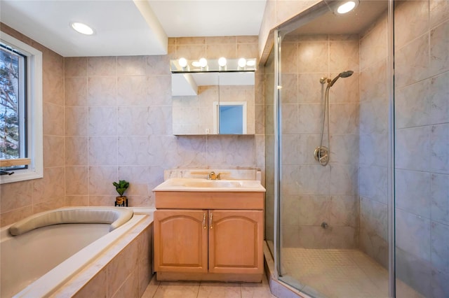 full bath with a garden tub, tile walls, recessed lighting, a shower stall, and vanity