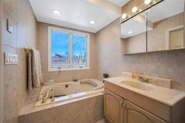 full bathroom with a bath, recessed lighting, tile walls, and vanity