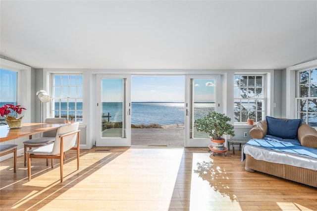 sunroom / solarium featuring a water view