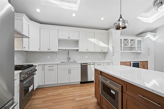 kitchen with white cabinetry, a skylight, and appliances with stainless steel finishes