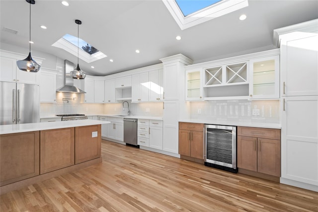 kitchen with wine cooler, white cabinetry, appliances with stainless steel finishes, and decorative light fixtures