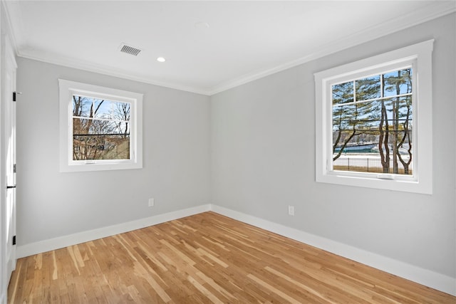 empty room with light hardwood / wood-style flooring and ornamental molding