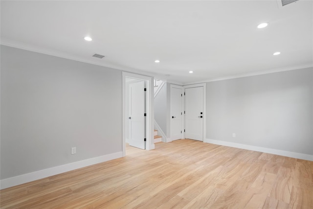 spare room with crown molding and light hardwood / wood-style flooring