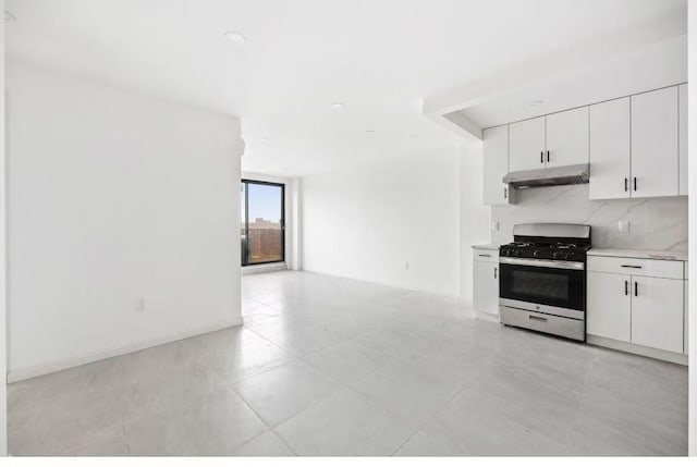 kitchen with tasteful backsplash, stainless steel range with gas cooktop, and white cabinets