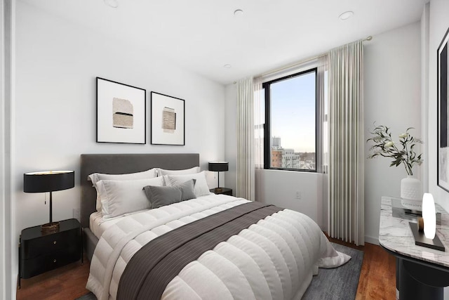 bedroom with dark hardwood / wood-style flooring