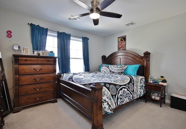 bedroom featuring ceiling fan, visible vents, and light colored carpet