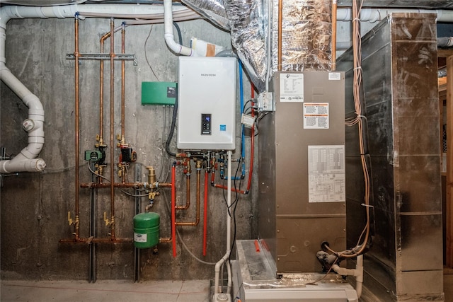 utility room with heating unit and water heater