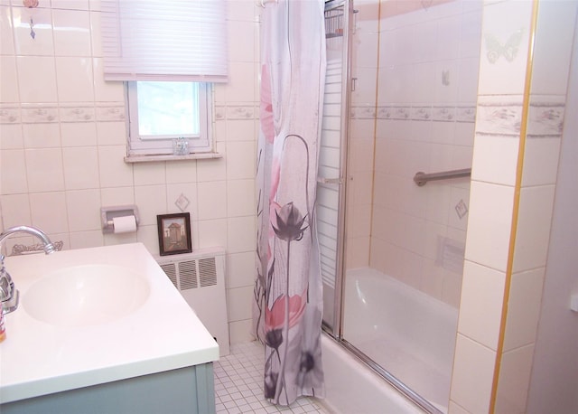 bathroom featuring tile walls, radiator heating unit, vanity, shower / bath combination with curtain, and tile patterned floors