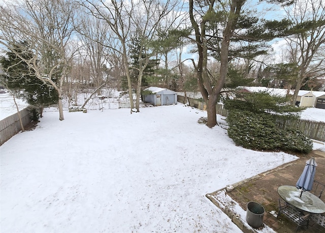 yard covered in snow with an outdoor structure