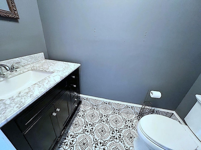 bathroom with vanity, tile patterned floors, and toilet