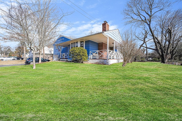 view of home's exterior featuring covered porch and a lawn