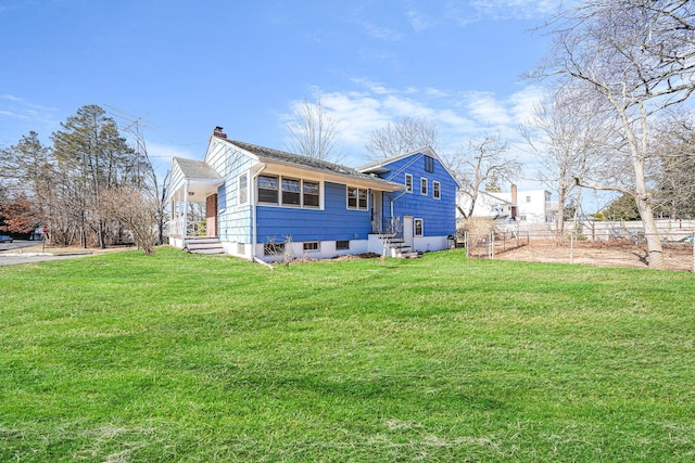 rear view of house with a lawn