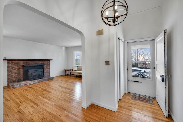 foyer entrance with an inviting chandelier and light hardwood / wood-style flooring