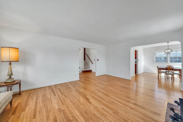 living room featuring a notable chandelier and light hardwood / wood-style flooring