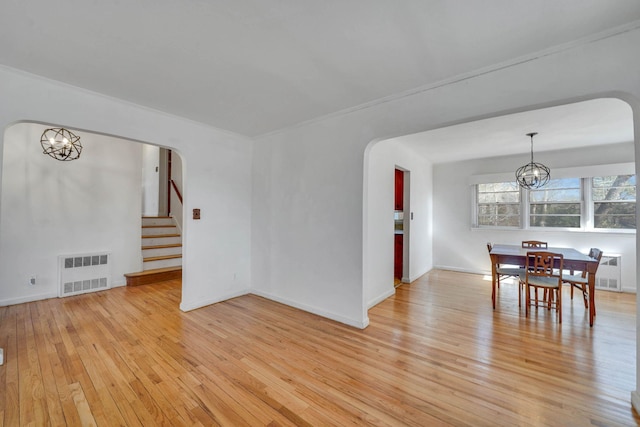 dining room with an inviting chandelier and light hardwood / wood-style floors