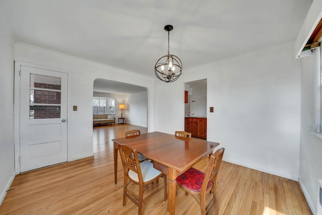 dining room featuring an inviting chandelier and light hardwood / wood-style flooring