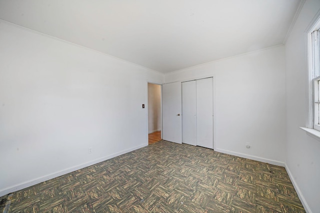 unfurnished bedroom with crown molding and a closet