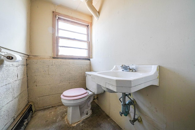 bathroom with concrete floors and toilet