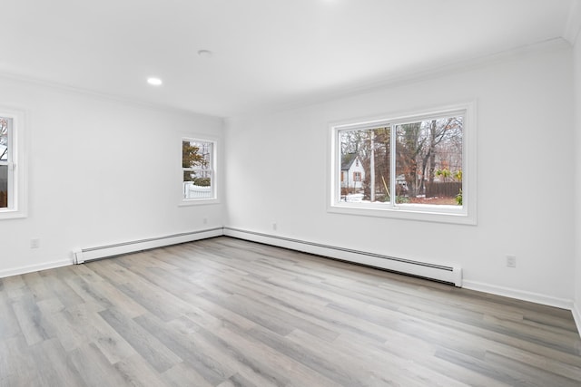 empty room featuring light wood-style floors, recessed lighting, crown molding, and baseboards