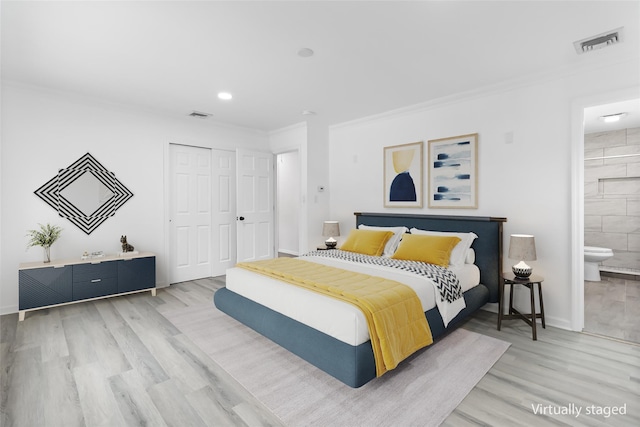 bedroom with a closet, visible vents, crown molding, and light wood-style flooring