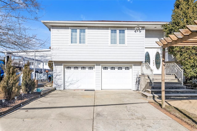 view of front facade with concrete driveway and an attached garage