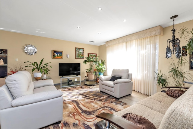 living room featuring light wood-type flooring, visible vents, and recessed lighting