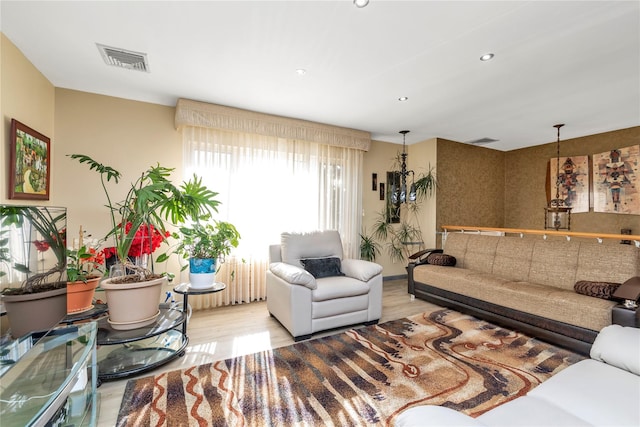 living room featuring light wood-type flooring, visible vents, and recessed lighting