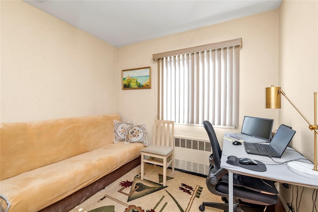 carpeted office space with radiator