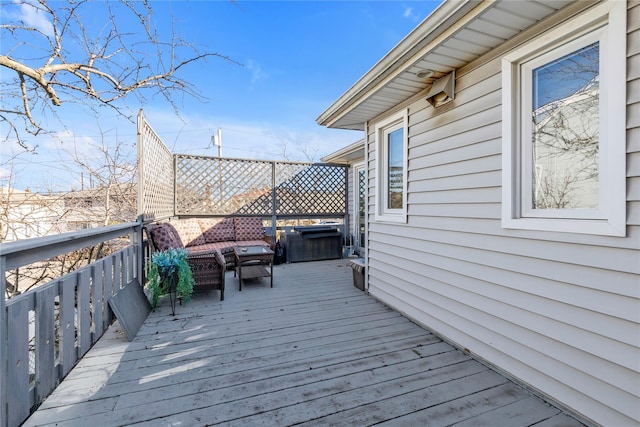 deck featuring a jacuzzi and grilling area