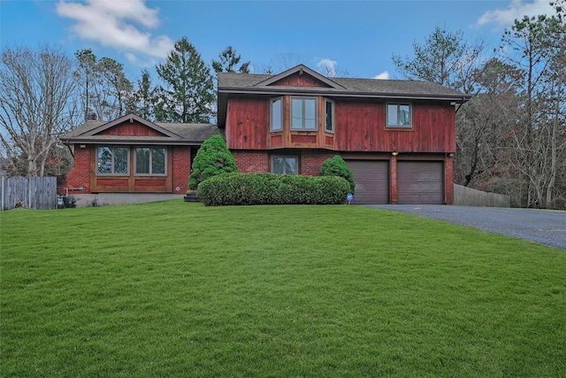 view of front of property featuring a garage and a front lawn