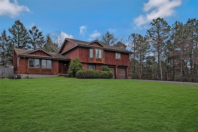 view of front of property featuring a garage and a front yard