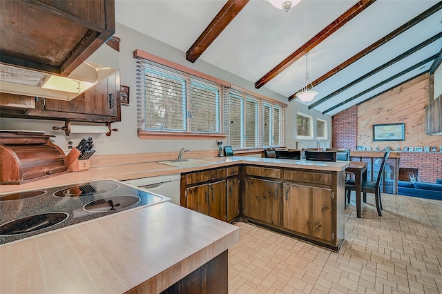 kitchen with sink, stovetop, vaulted ceiling with beams, white dishwasher, and kitchen peninsula