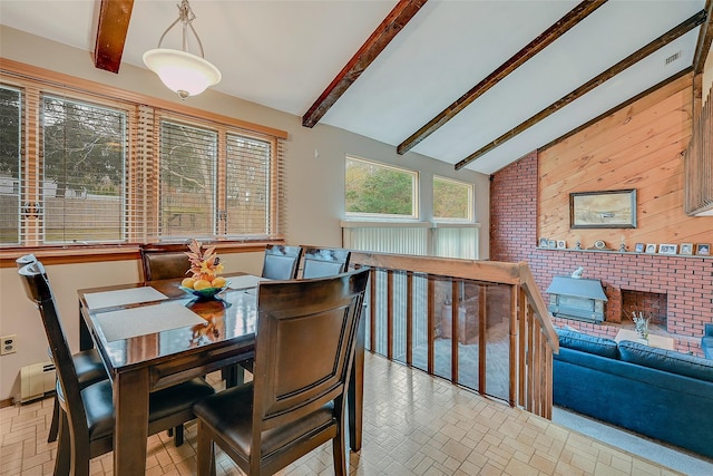 dining room featuring vaulted ceiling with beams, baseboard heating, and wood walls