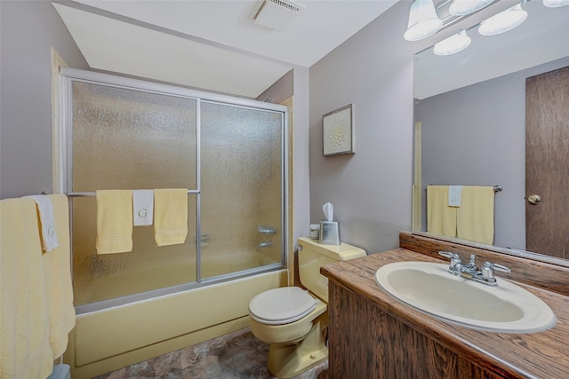 full bathroom featuring vanity, shower / bath combination with glass door, and toilet