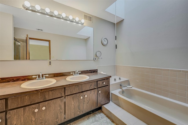 bathroom with vanity and a tub to relax in