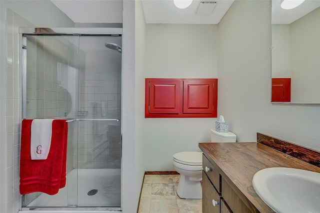 bathroom with vanity, an enclosed shower, and toilet