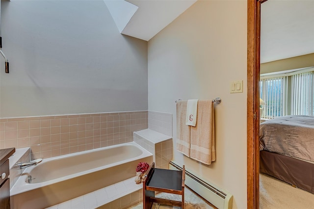 bathroom with tiled bath and a baseboard heating unit