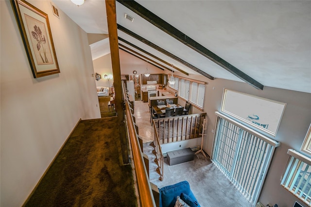 hall with carpet flooring and vaulted ceiling with beams