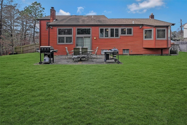 back of property featuring a patio area and a lawn