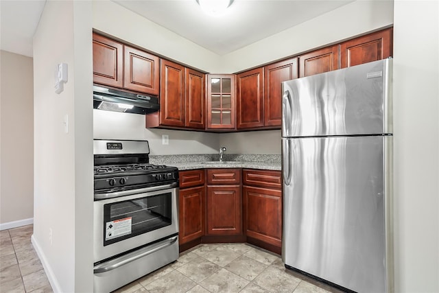 kitchen featuring stainless steel appliances, sink, light tile patterned floors, and light stone counters