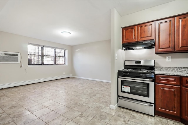 kitchen with baseboard heating, a wall mounted air conditioner, light stone counters, and stainless steel gas stove