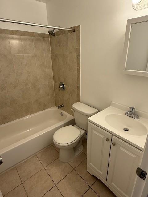 full bathroom with tiled shower / bath, tile patterned floors, toilet, and vanity