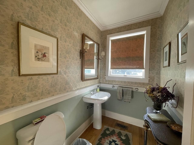 bathroom featuring crown molding, wood-type flooring, toilet, and sink