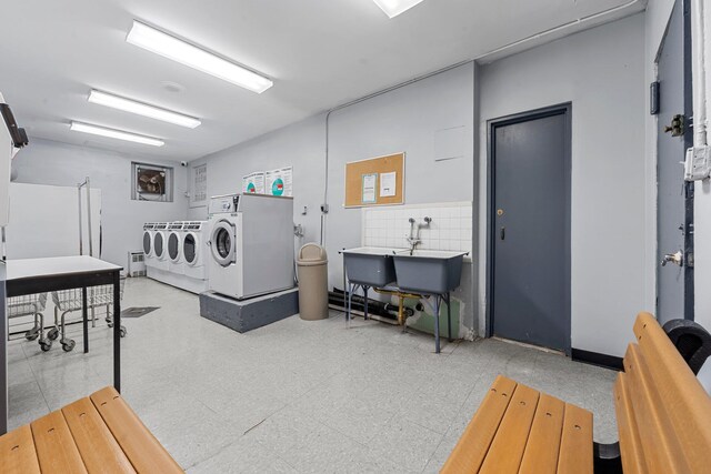 1275 E 51st St Unit 3Y, Brooklyn, NY 11234 - washroom featuring sink, washer and dryer, and tile walls