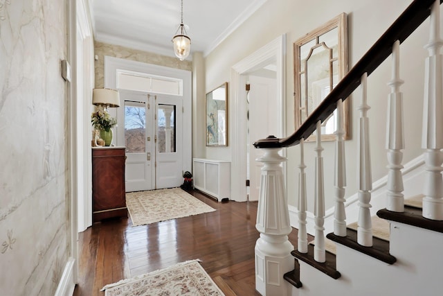 entryway with stairs, ornamental molding, dark wood finished floors, and french doors