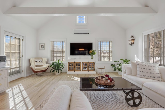 living area featuring light wood-type flooring, a wall unit AC, vaulted ceiling with beams, and baseboards