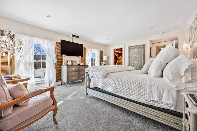 carpeted bedroom featuring a notable chandelier