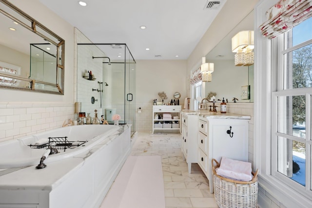 full bath featuring a stall shower, a garden tub, vanity, and recessed lighting