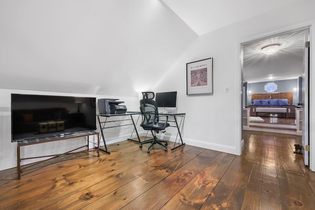 office area featuring lofted ceiling, wood-type flooring, and baseboards