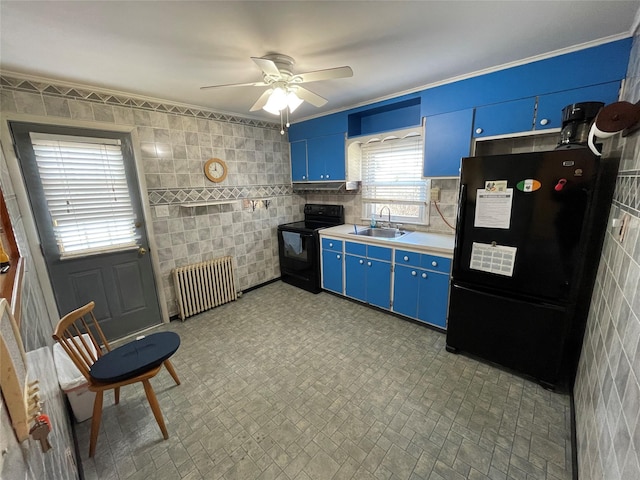 kitchen featuring radiator, black appliances, blue cabinets, and a sink